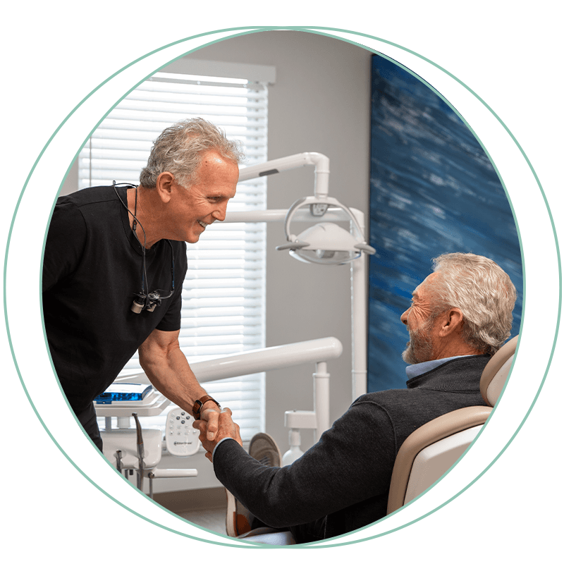 dr and older gentlemen with happy handshake