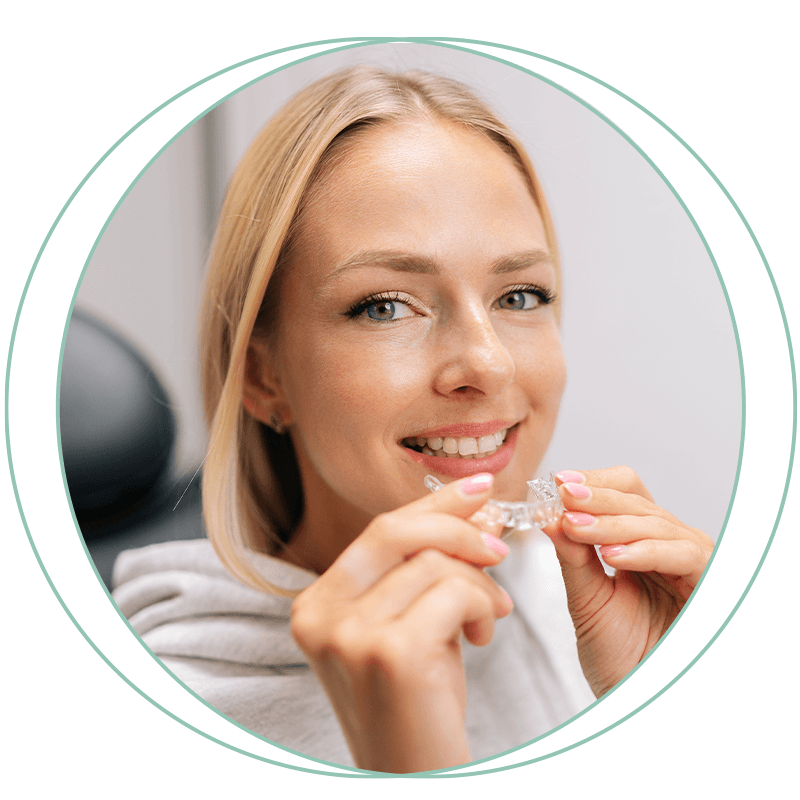 lady with hoodie holding aligner